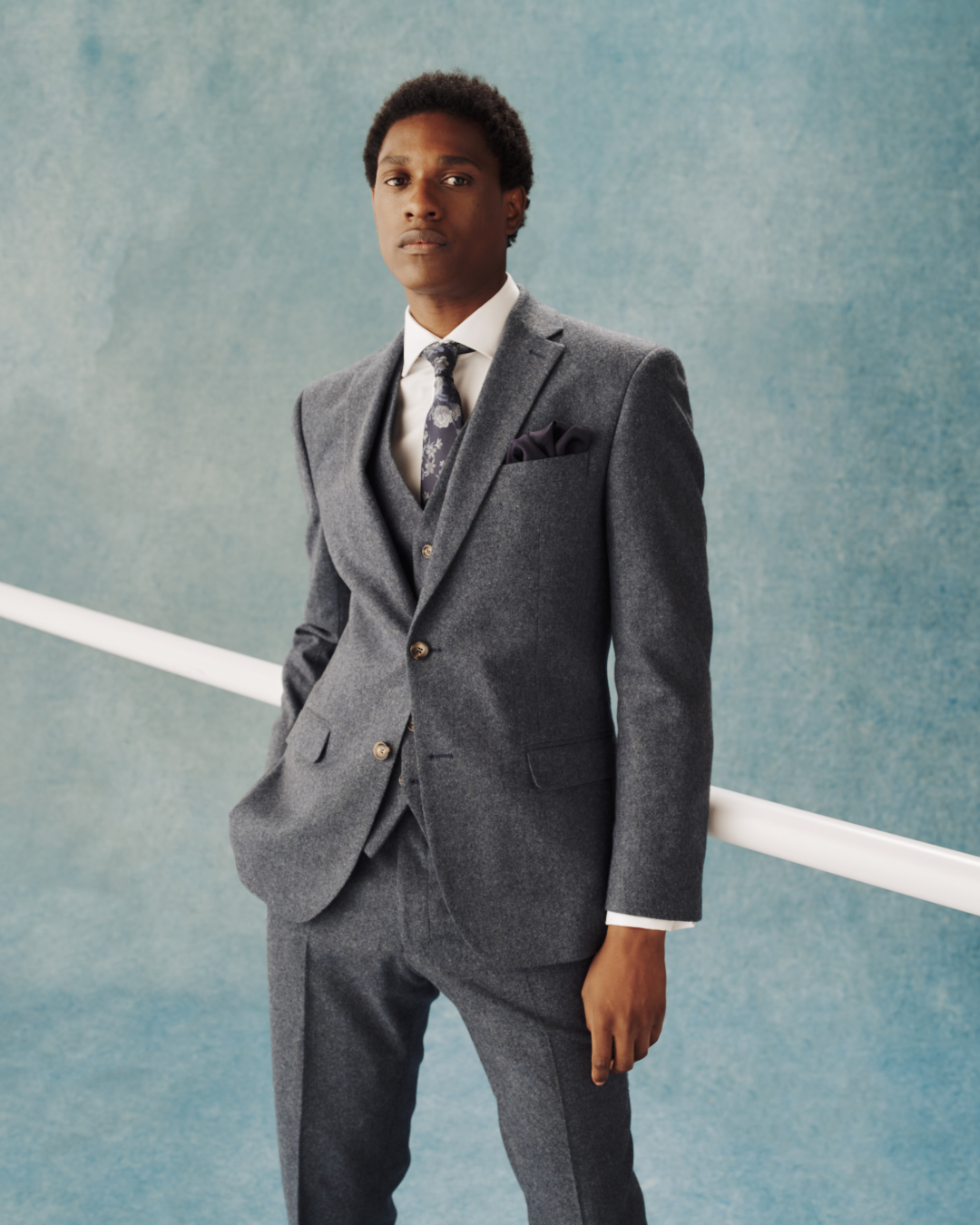 A model wearing a grey three-piece suit
