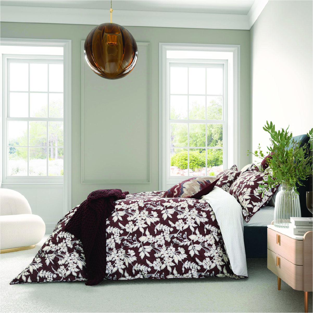 Beautiful bed spread in a white room with natural light