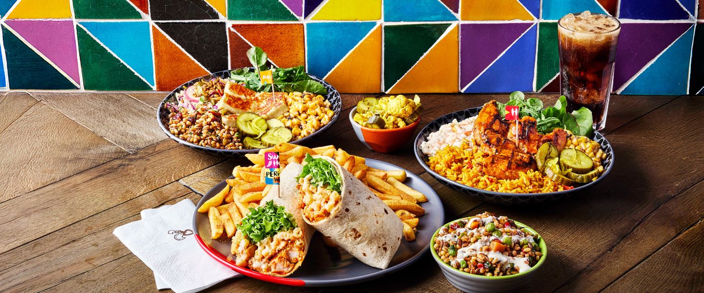 A table full of new Nando's dishes