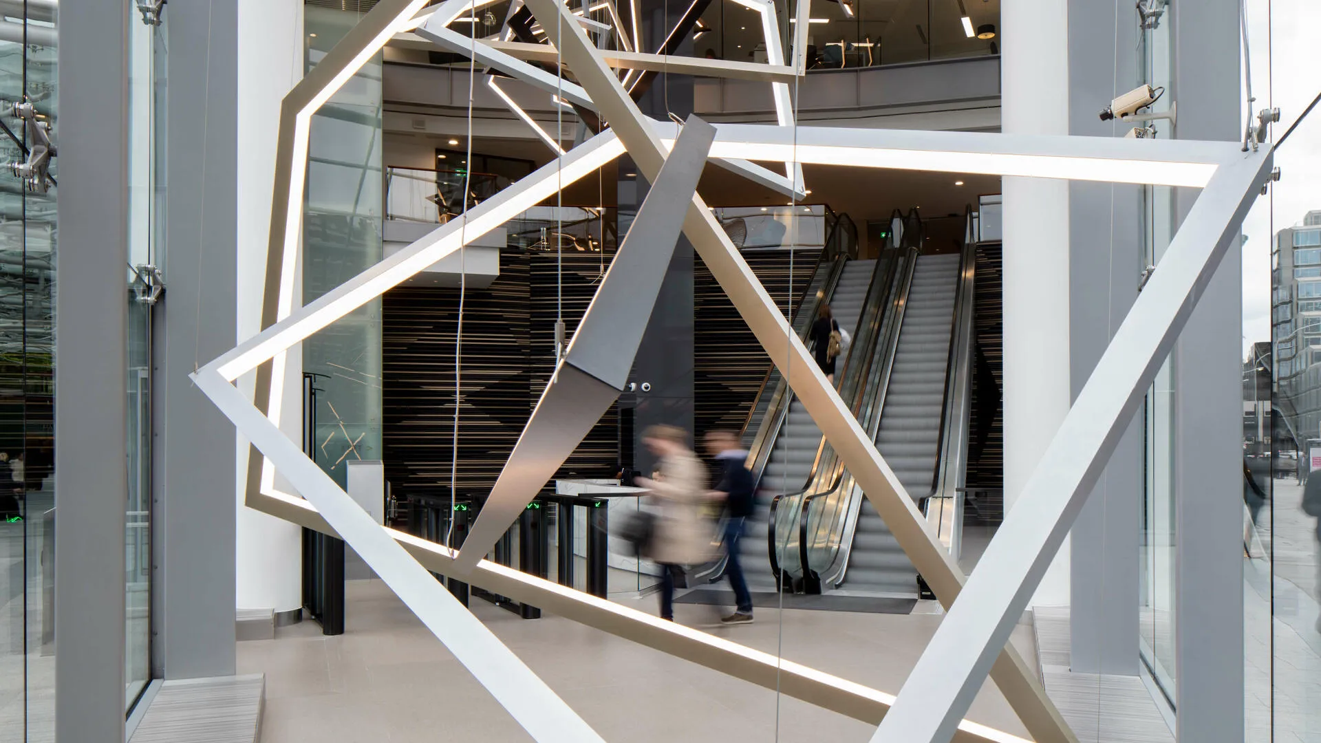 Modern interior with geometric metallic structure and escalators