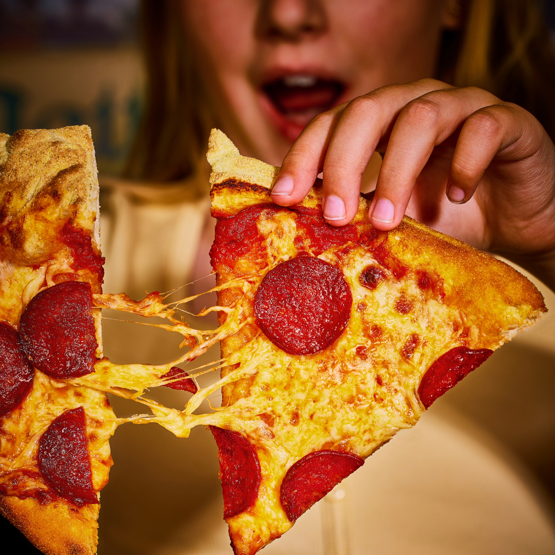 Child eating pizza at Frankie & Benny's