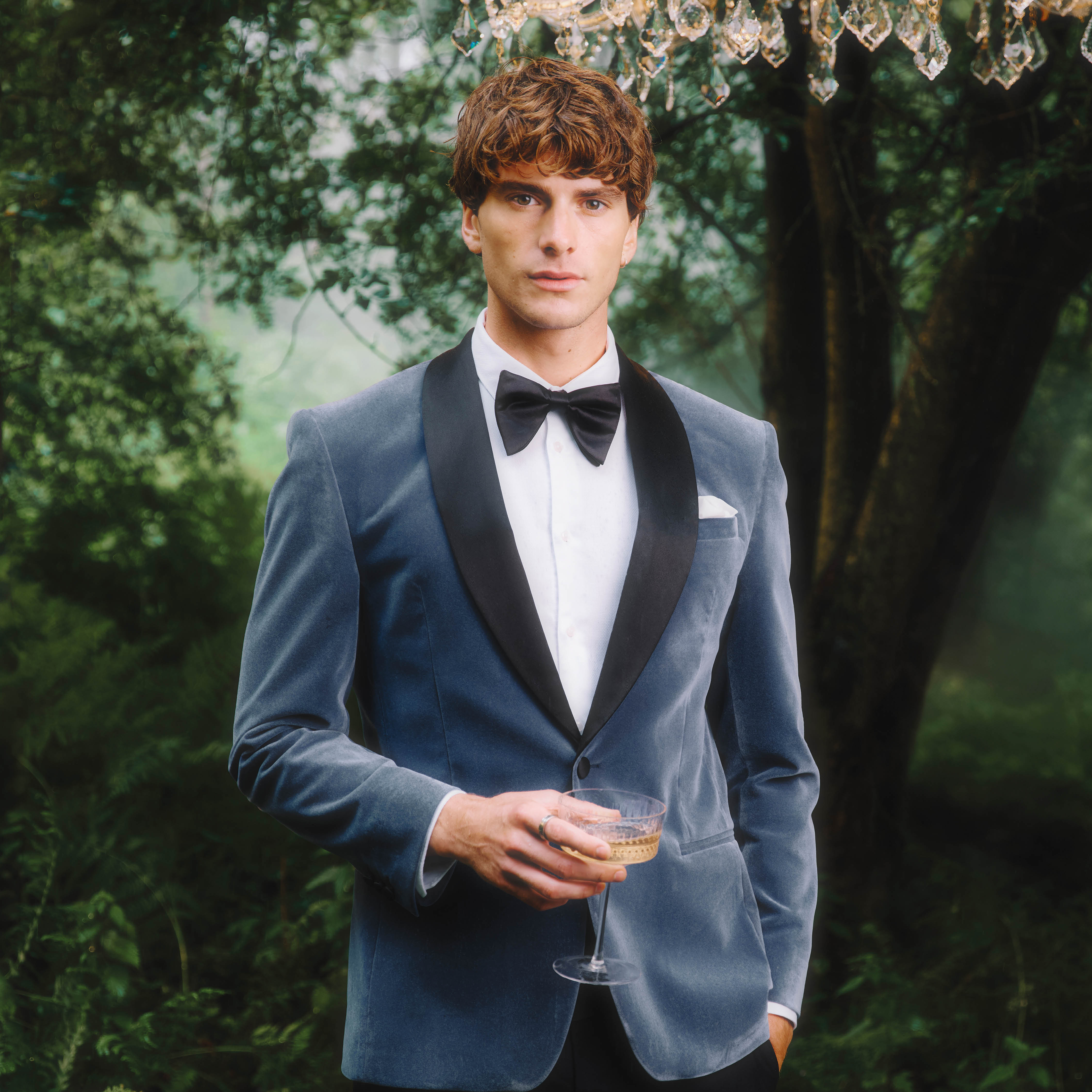 A man outside in a blue velvet blazer