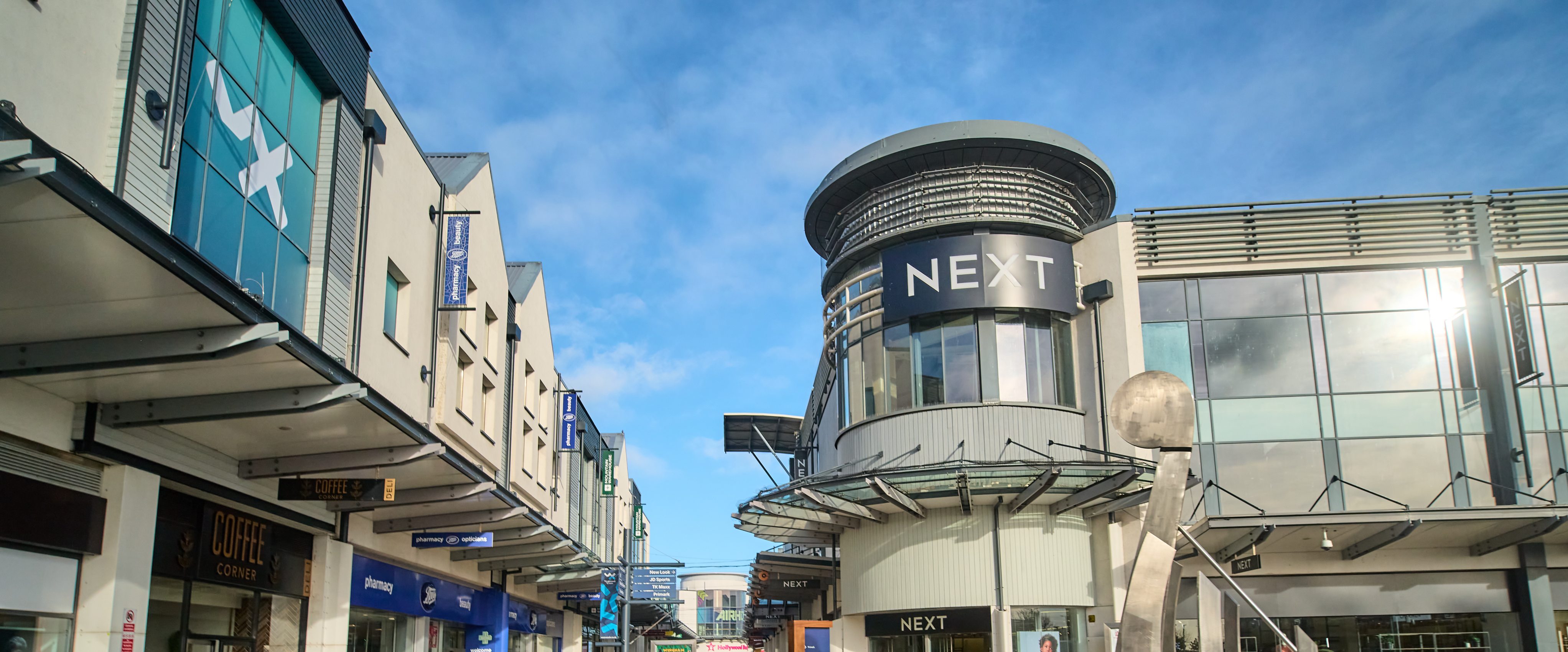 A close-up of the Westwood Cross logo on a building at the centre