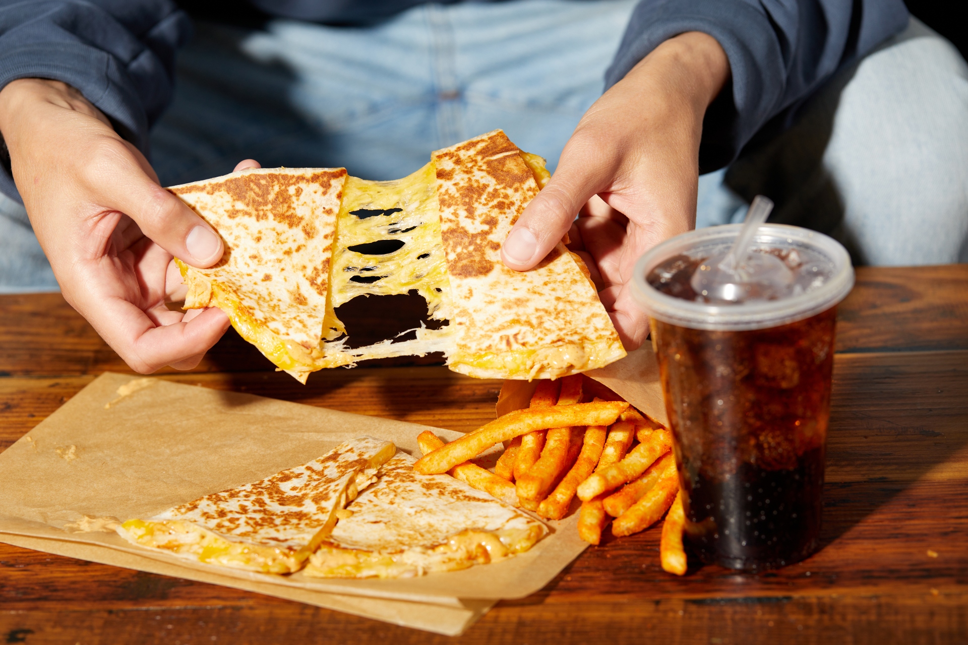 A student pulling apart a quesadilla
