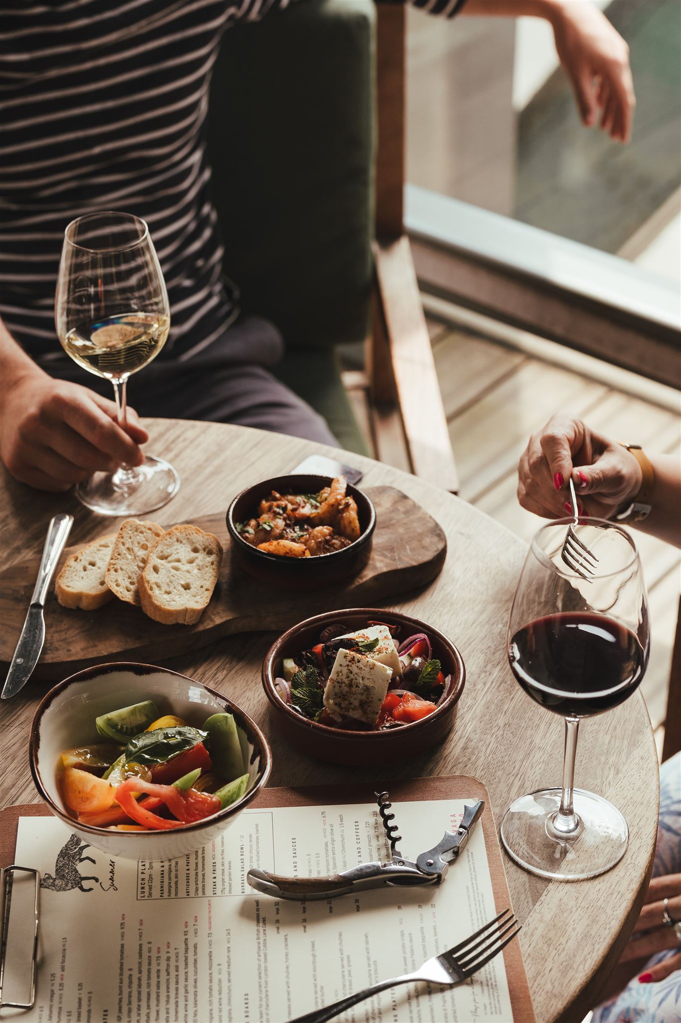Glasses of wine around tapas dishes