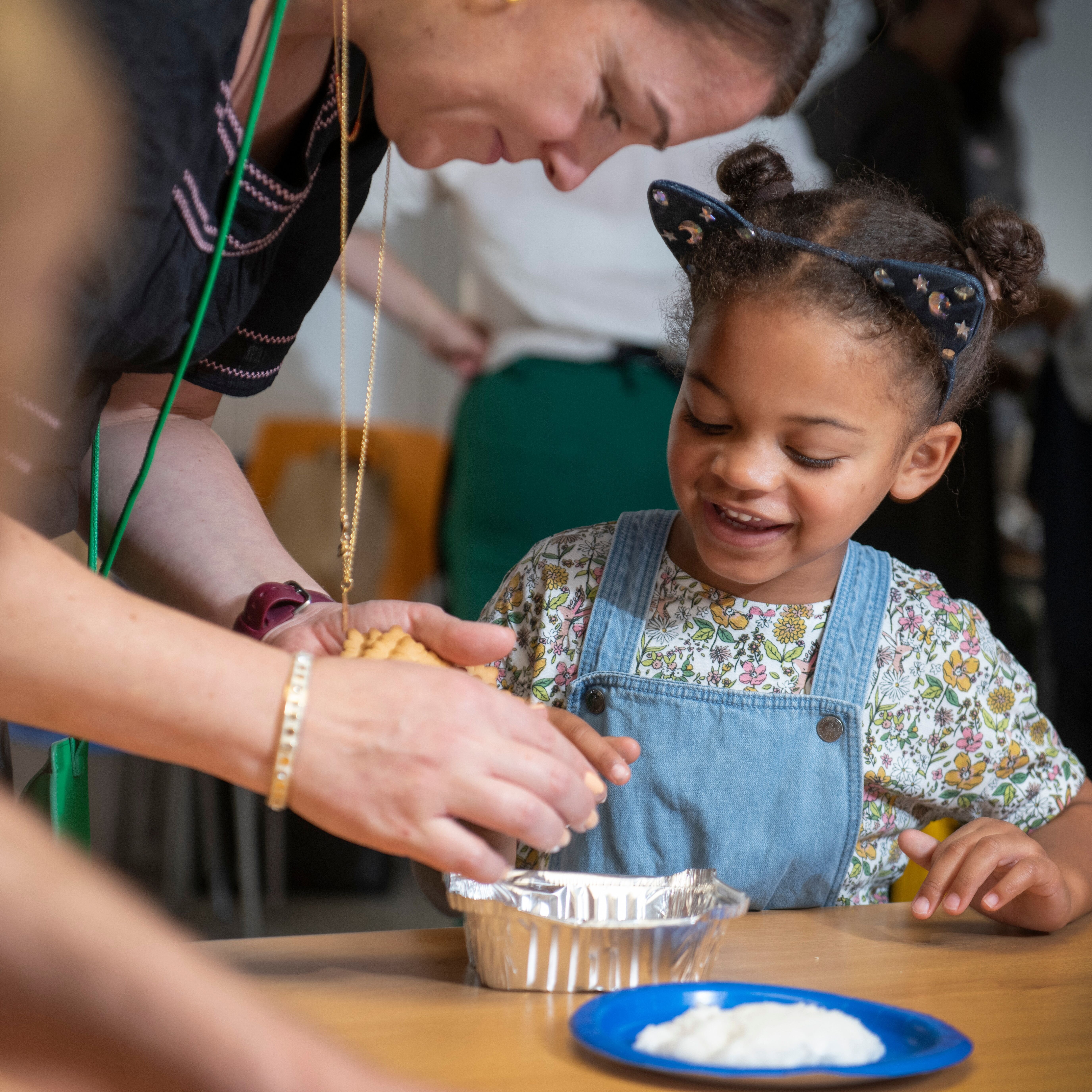 A child taking part in an activity with a foil bowl at London Museum Docklands