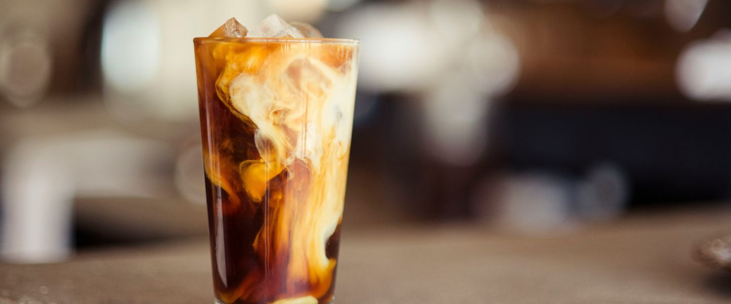 A glass of iced coffee on a table