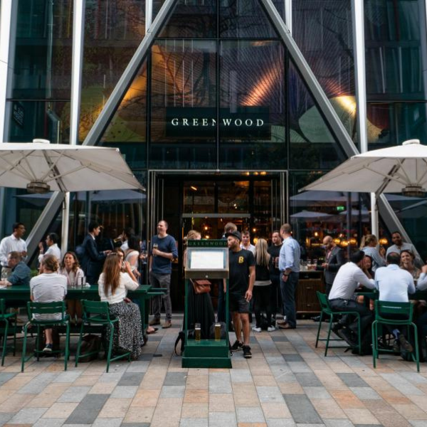 People sitting outside Greenwood enjoying food and drinks