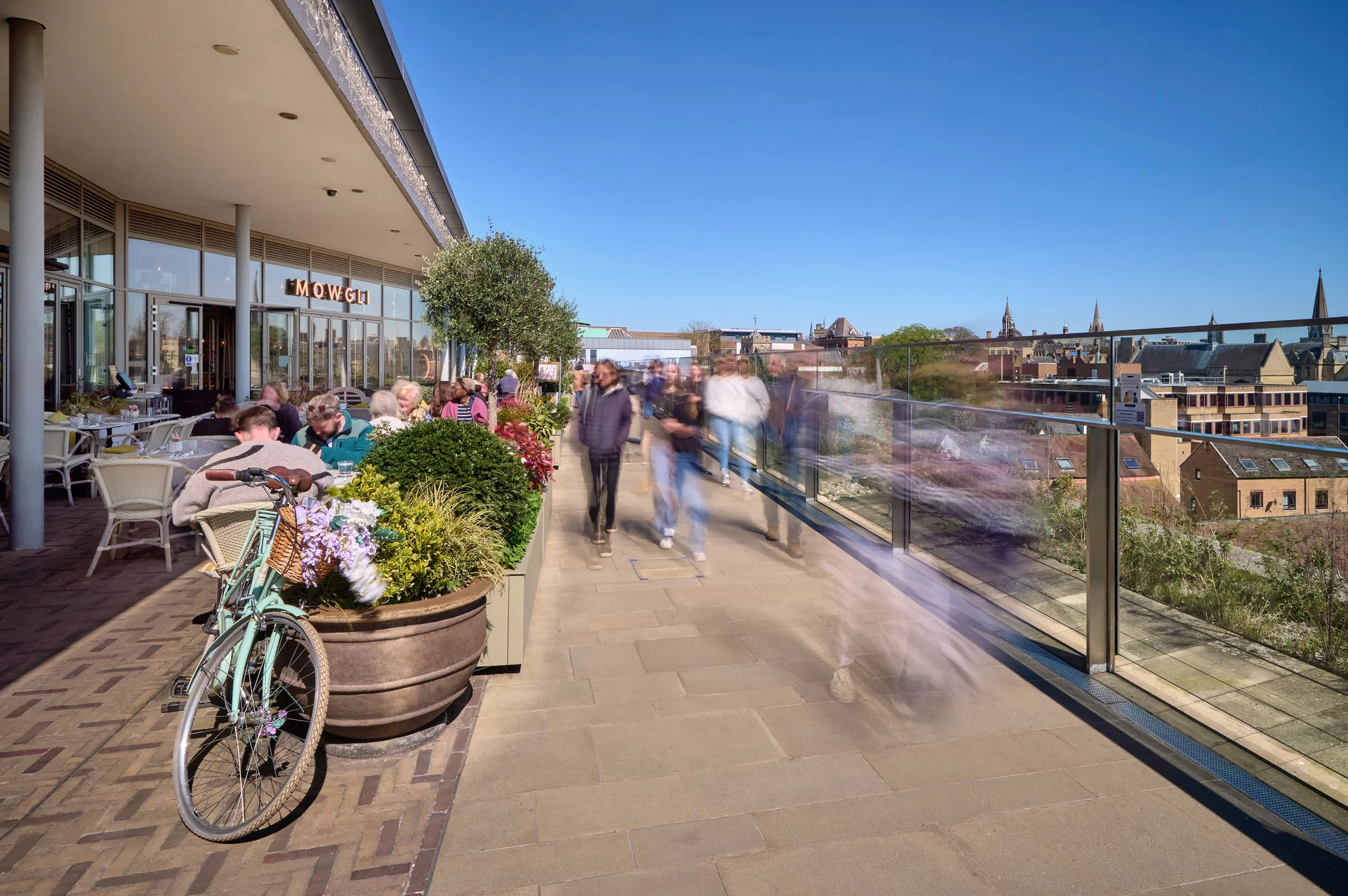 Sunny rooftop dining at Westgate Oxford. Mowgli restaurant terrace with views of the historic city skyline.