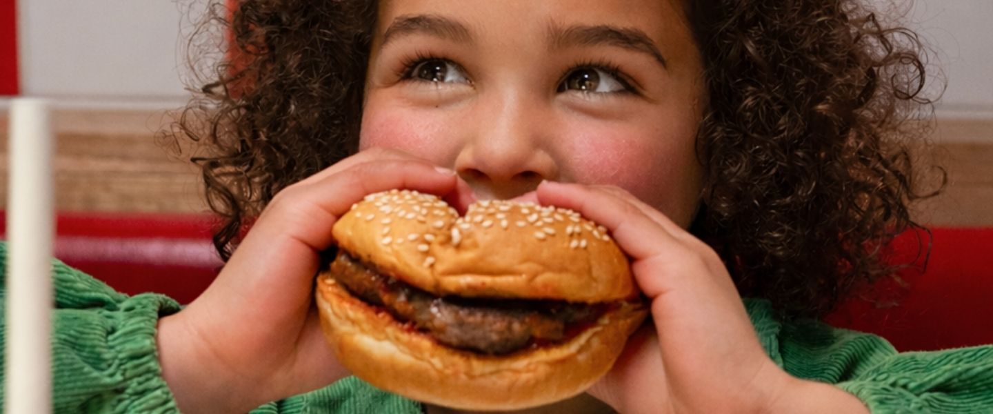 Child eating a Five Guys kids meal burger