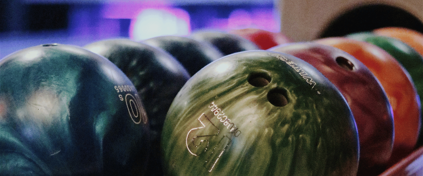 Two rows of multi coloured bowling balls