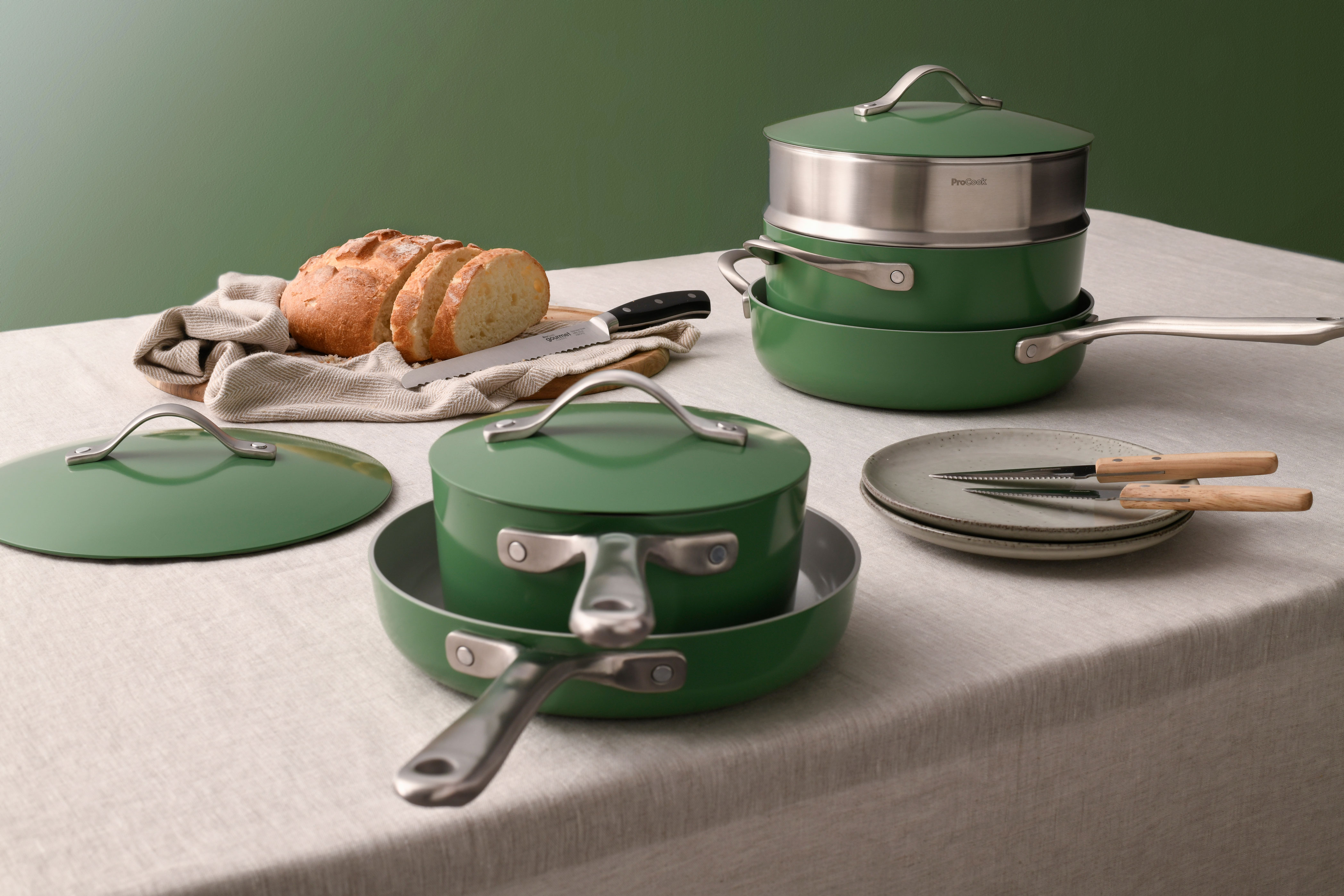 A selection of green cookware on a white table