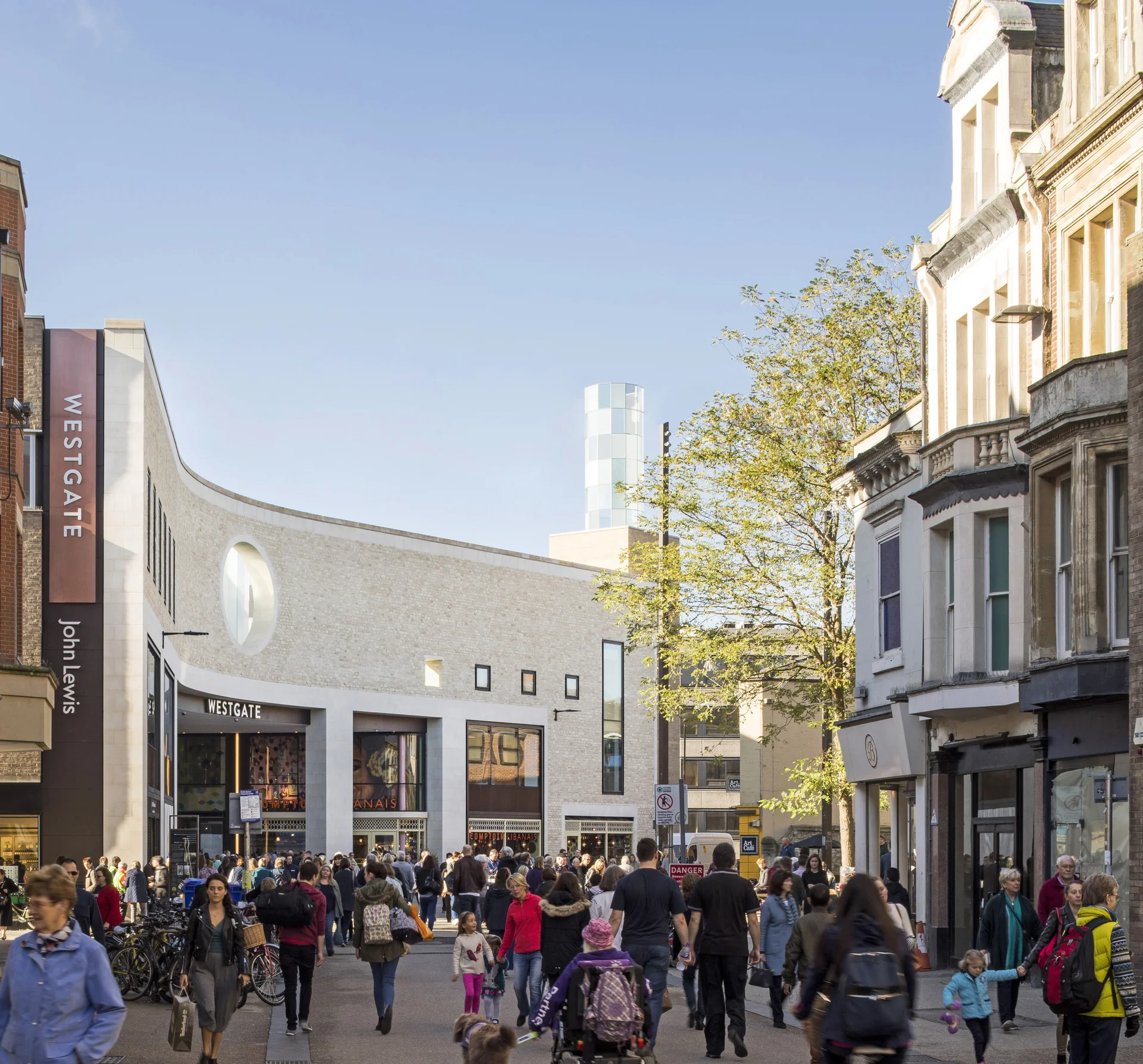 Busy street entrance to Westgate Oxford shopping centre and John Lewis. Traditional architecture meets modern design.