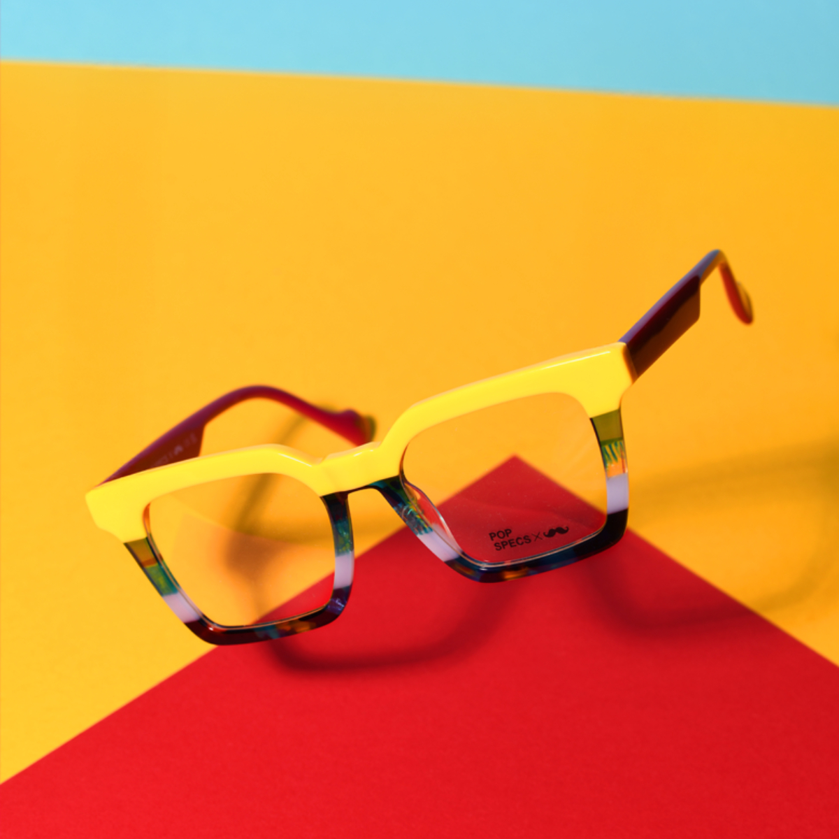 Glasses on coloured background