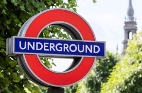 London Underground sign with green trees in the background