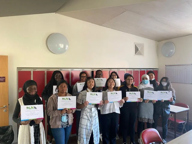 Group of people holding ALNL certificates.