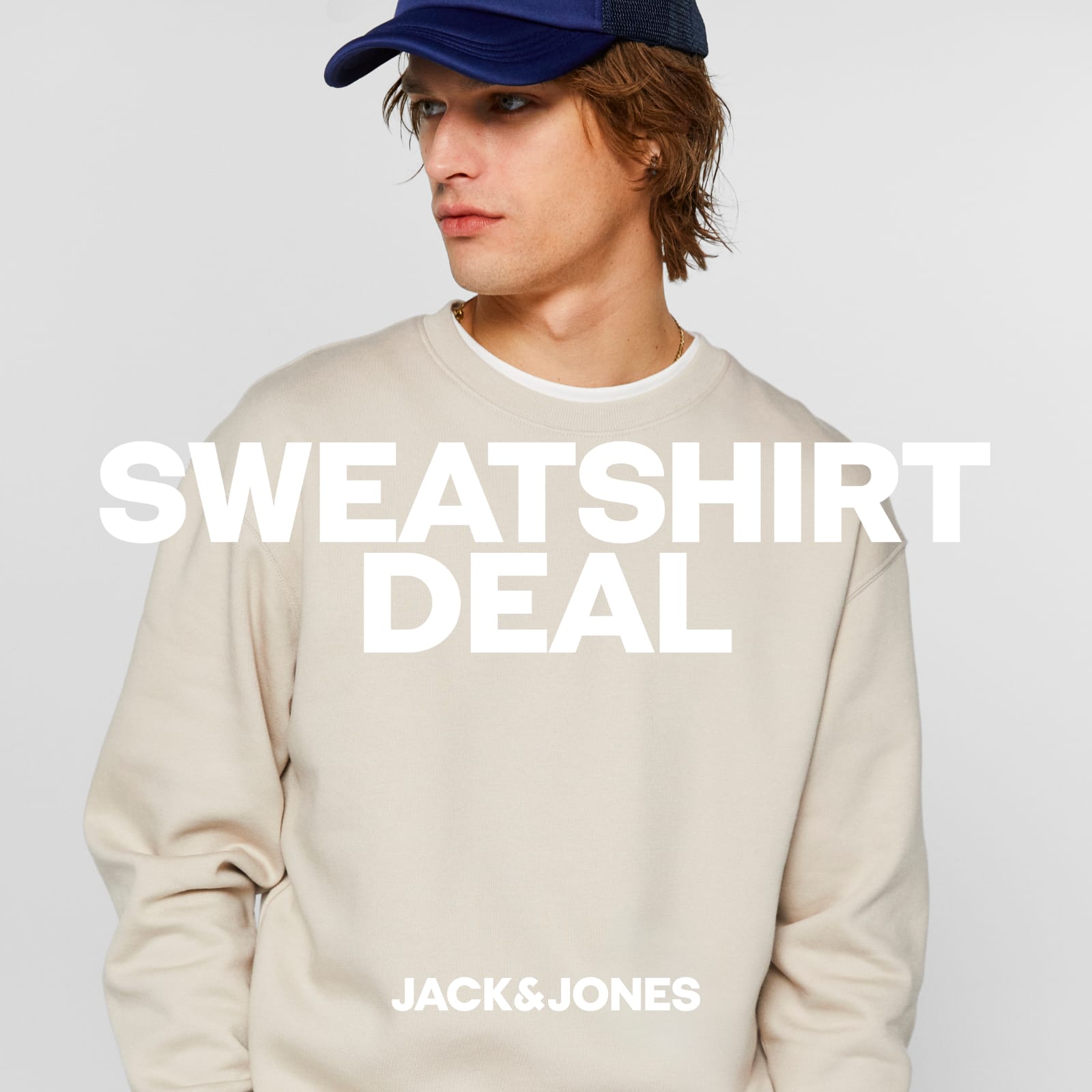 A man with a beige sweatshirt and a navy blue cap advertising 'sweatshirt deal'