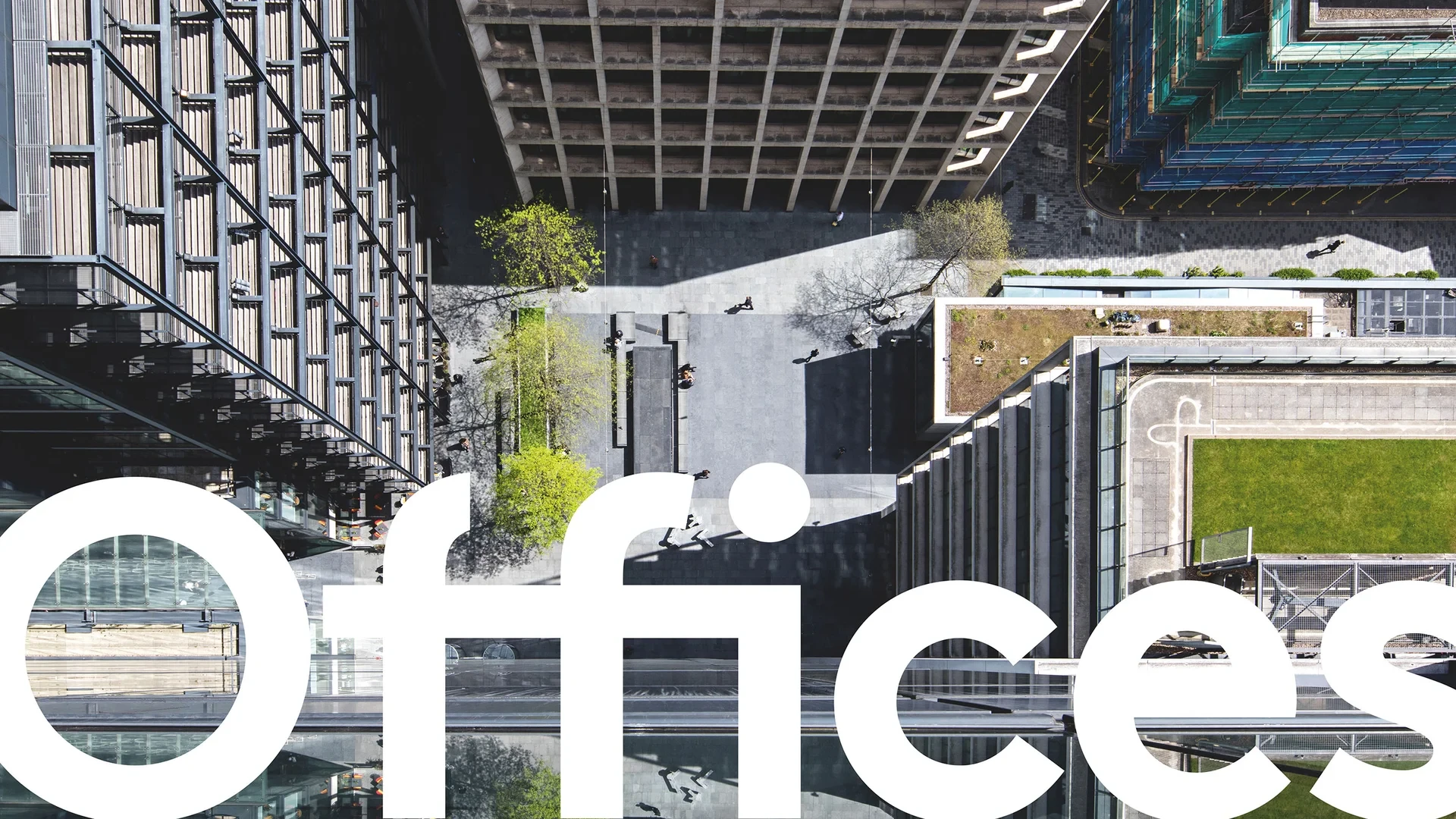Top-down view of a business district with tall office buildings and central courtyard, featuring large "Offices" text