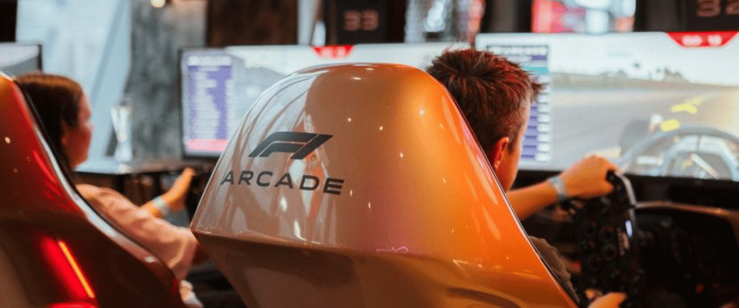 A boy using the F1 racing simulators at the F1 Arcade