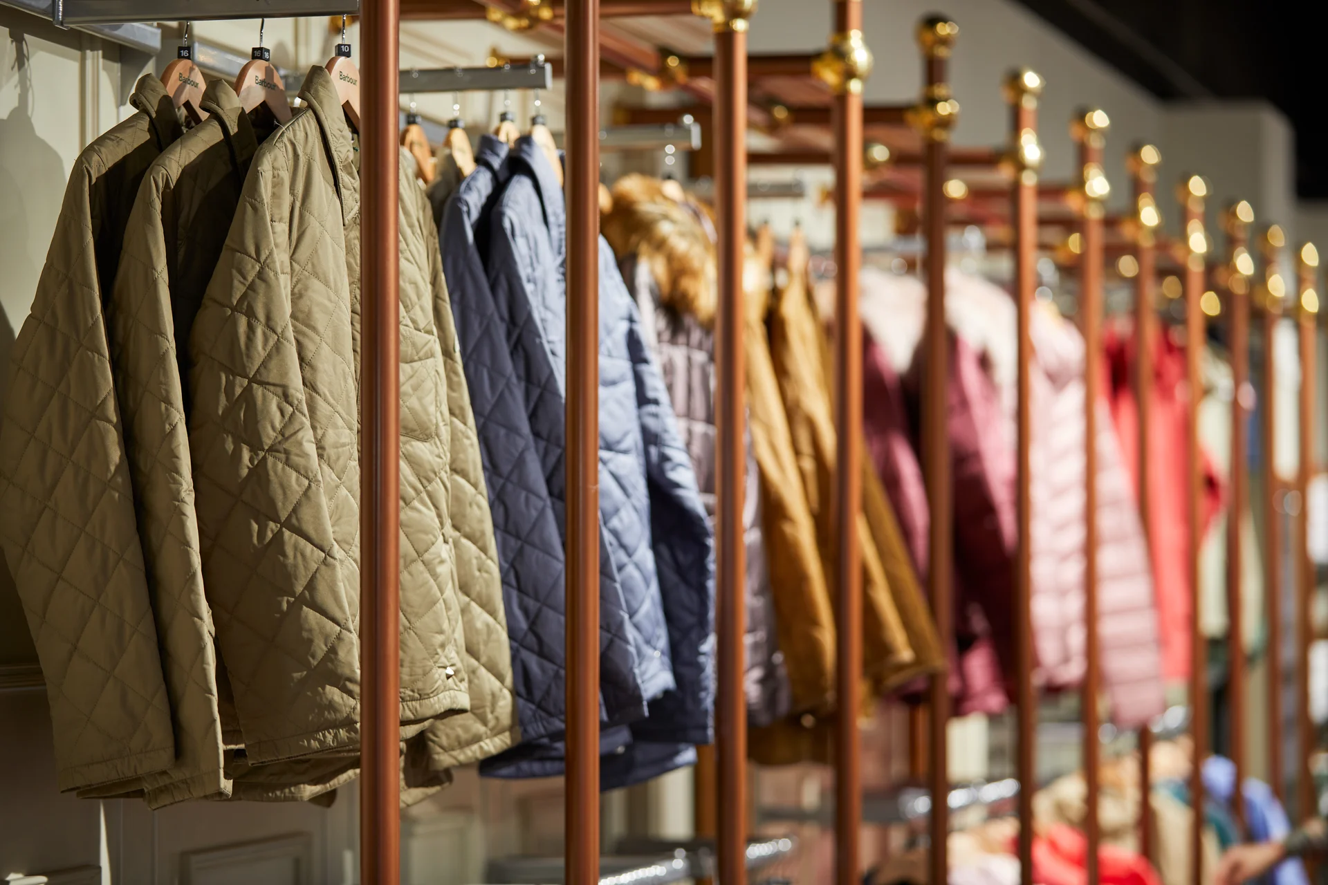 Quilted jackets in various colours hanging on a clothing rail