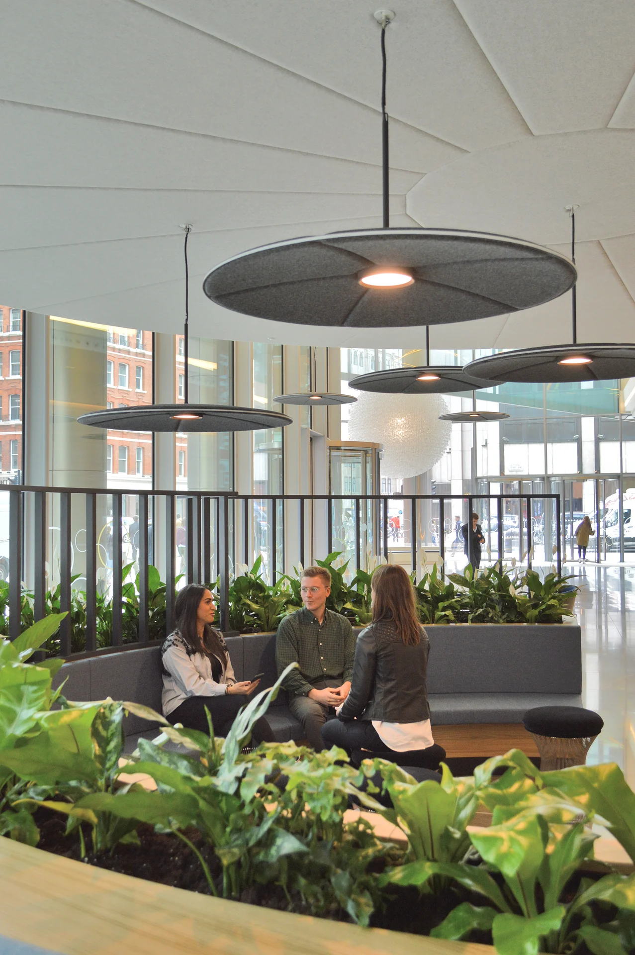 Spacious office reception area with plants and contemporary lighting