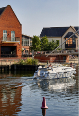 A boat on the water by the entrance to Riverside Entertainment