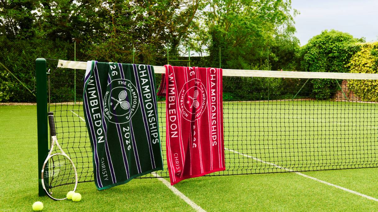 Two Christy Wimbledon towels draped over a tennis net