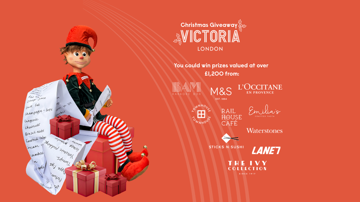 An image with a red background of a Christmas elf sitting on a stack of presents, with a list of logos in white next to him. Logos include Lane7, The Ivy, M&S, L'Occitane, Emilia's. Rail House Cafe