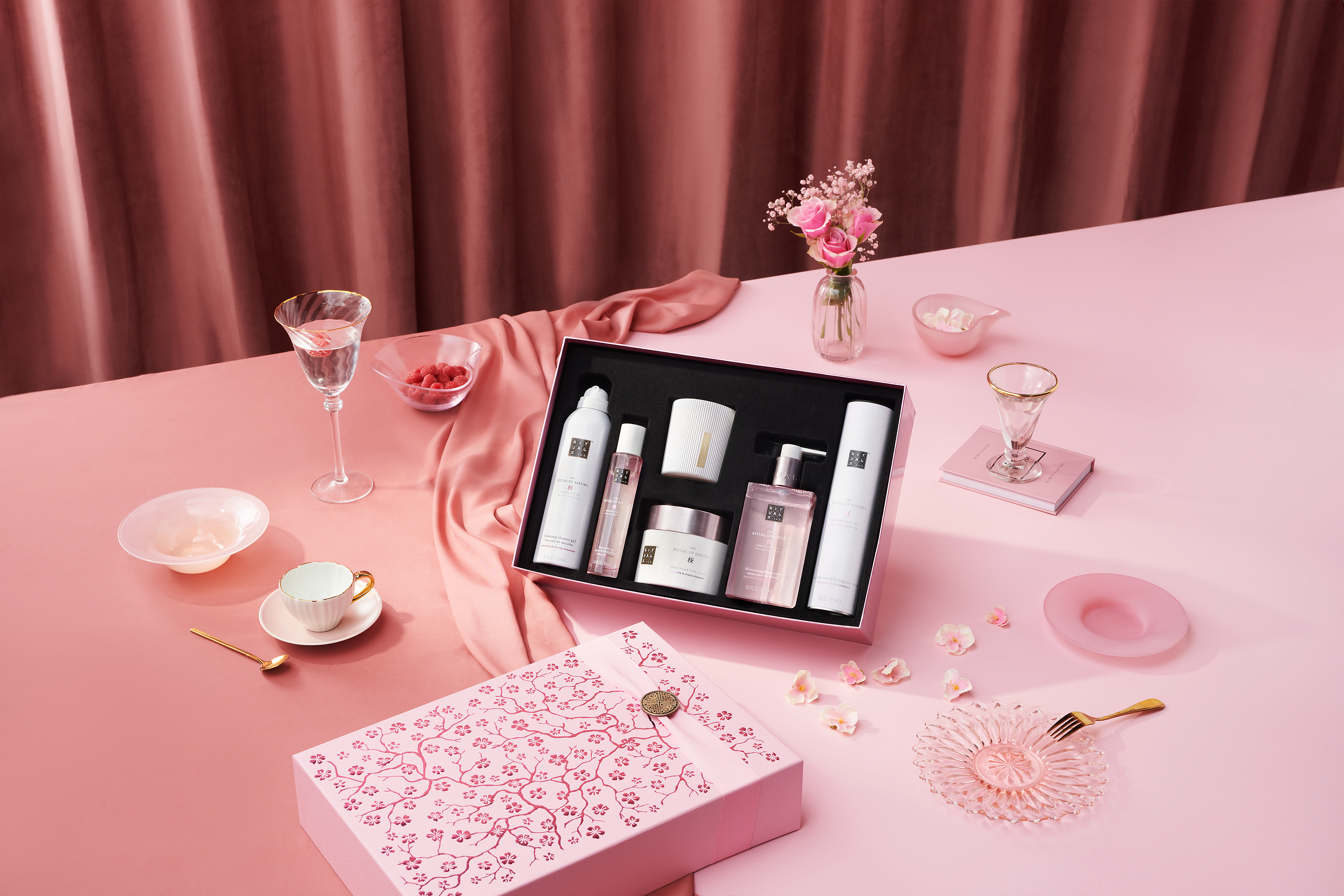 Rituals gift box on a pink surface with various ornaments