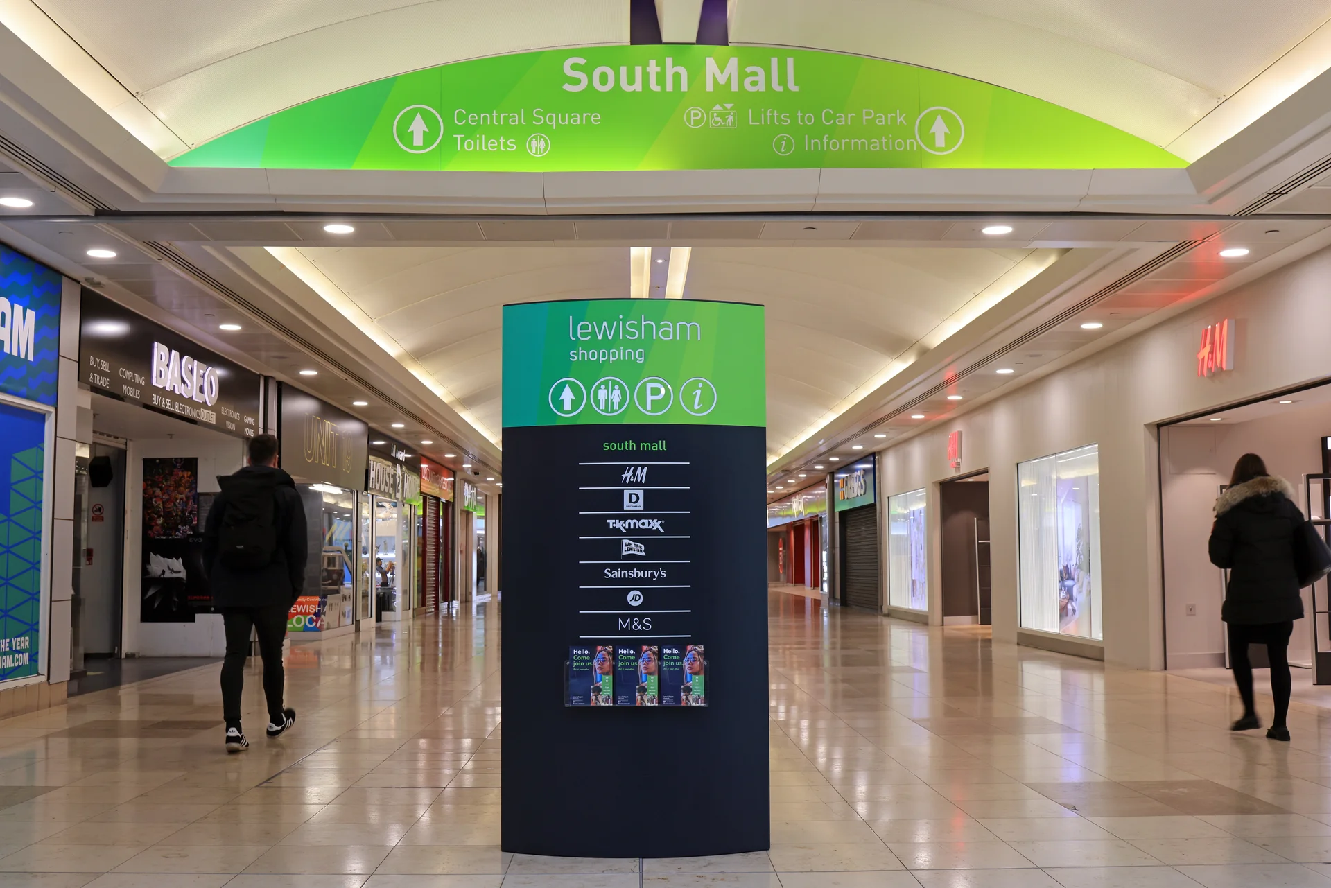 Interior of Lewisham Shopping Centre South Mall. Directory sign shows major stores like H&M, TK Maxx, M&S.