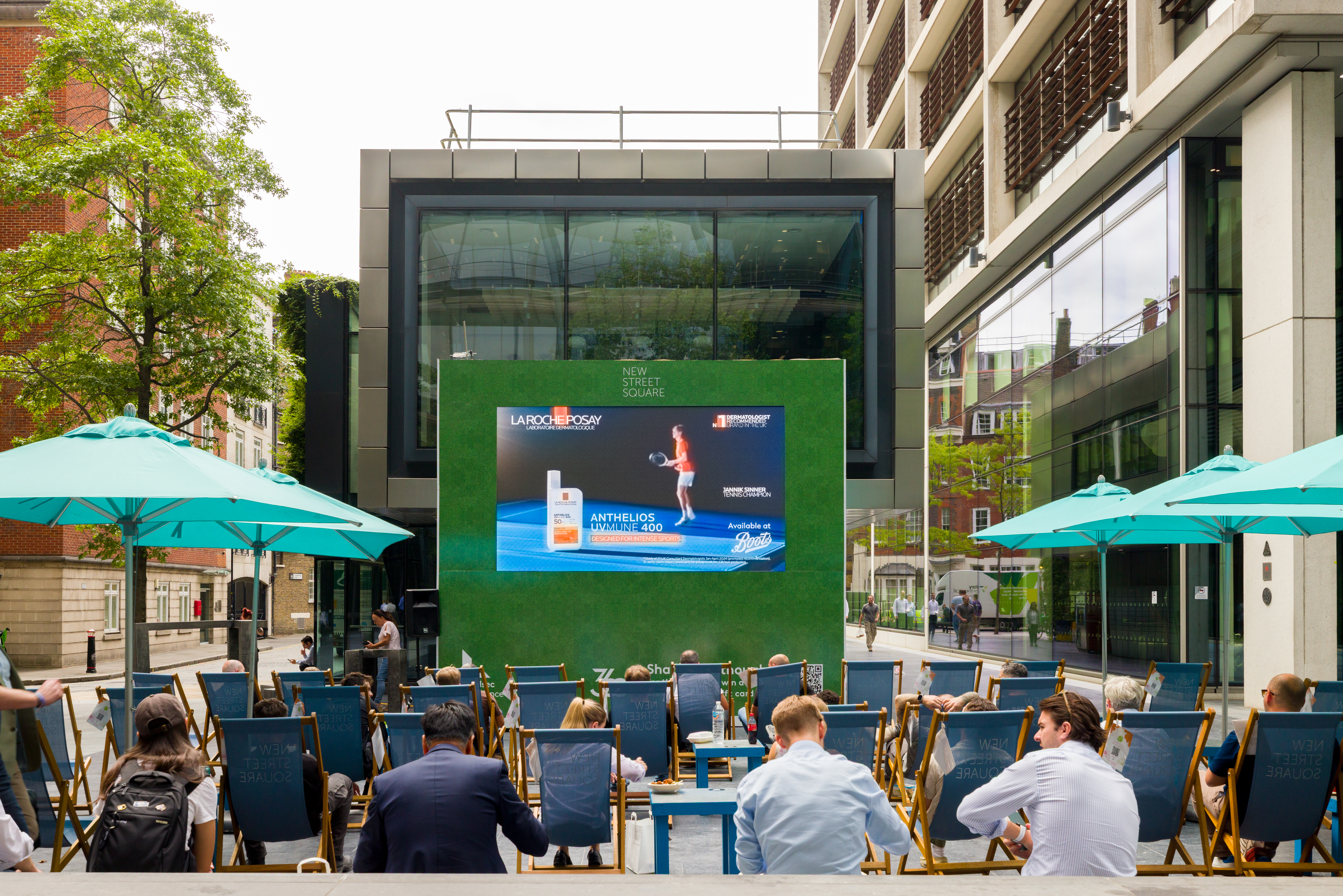 People watching tennis on the big screen at new street square