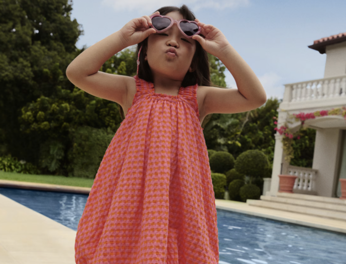 Young girl by swimming pool