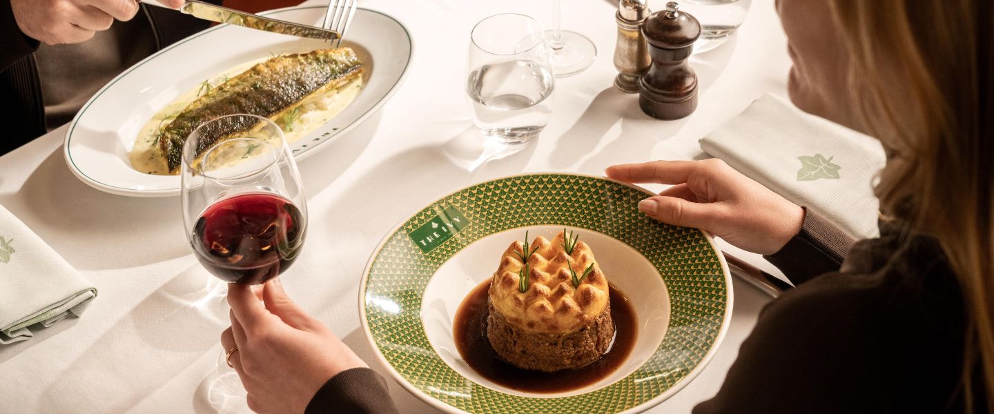 Two plates of food on a white tablecloth