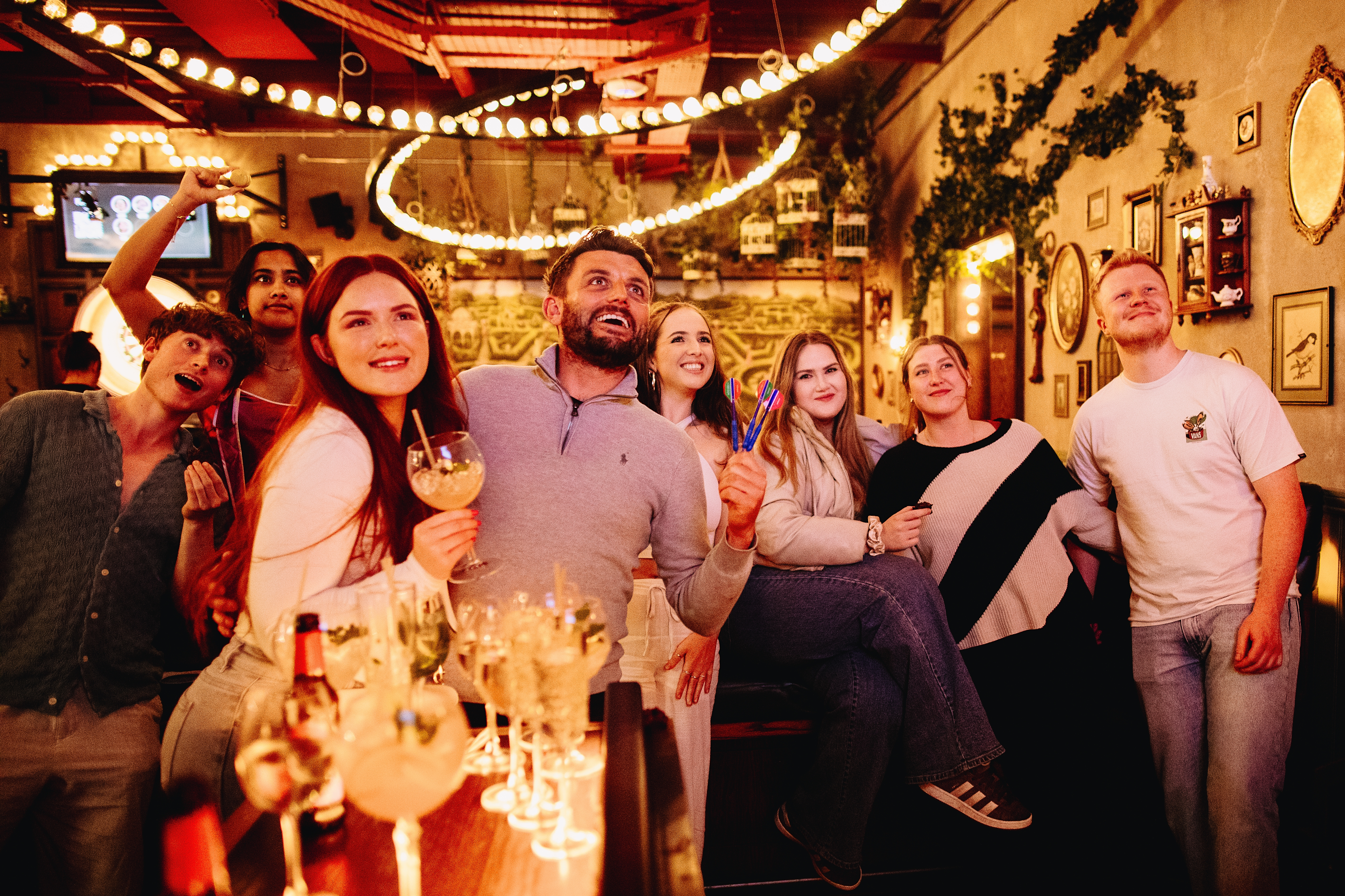 A group of friends playing darts