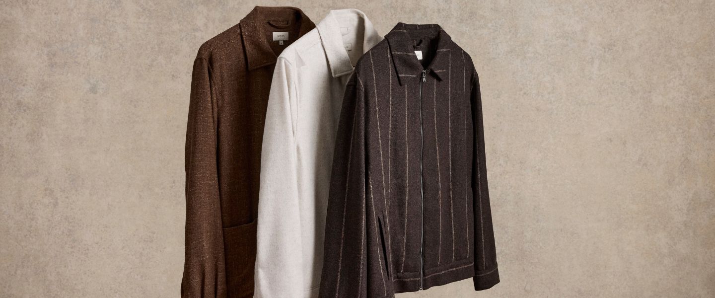 Three shirts and jackets on a beige background