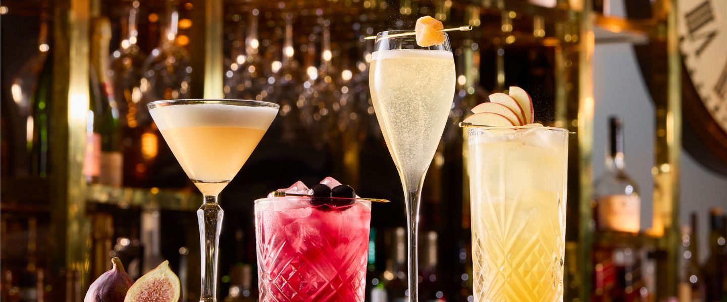 A row of cocktails on a bar