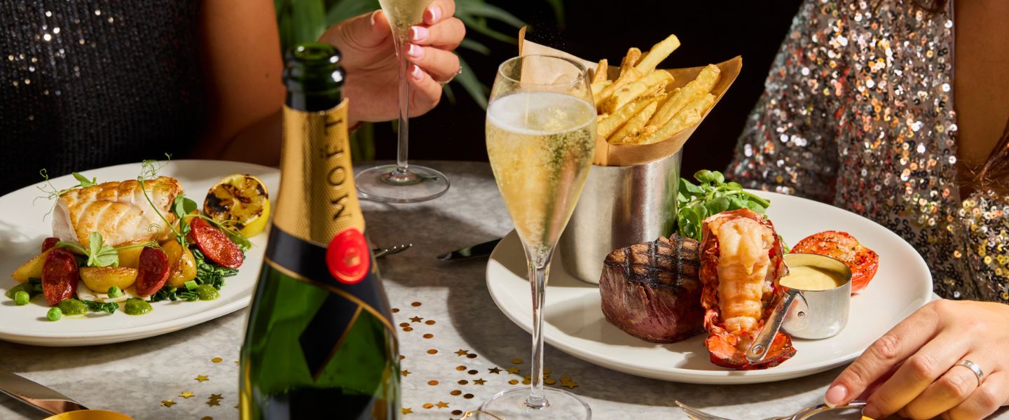 A festive dinner with glasses of champagne and a bottle of Moet