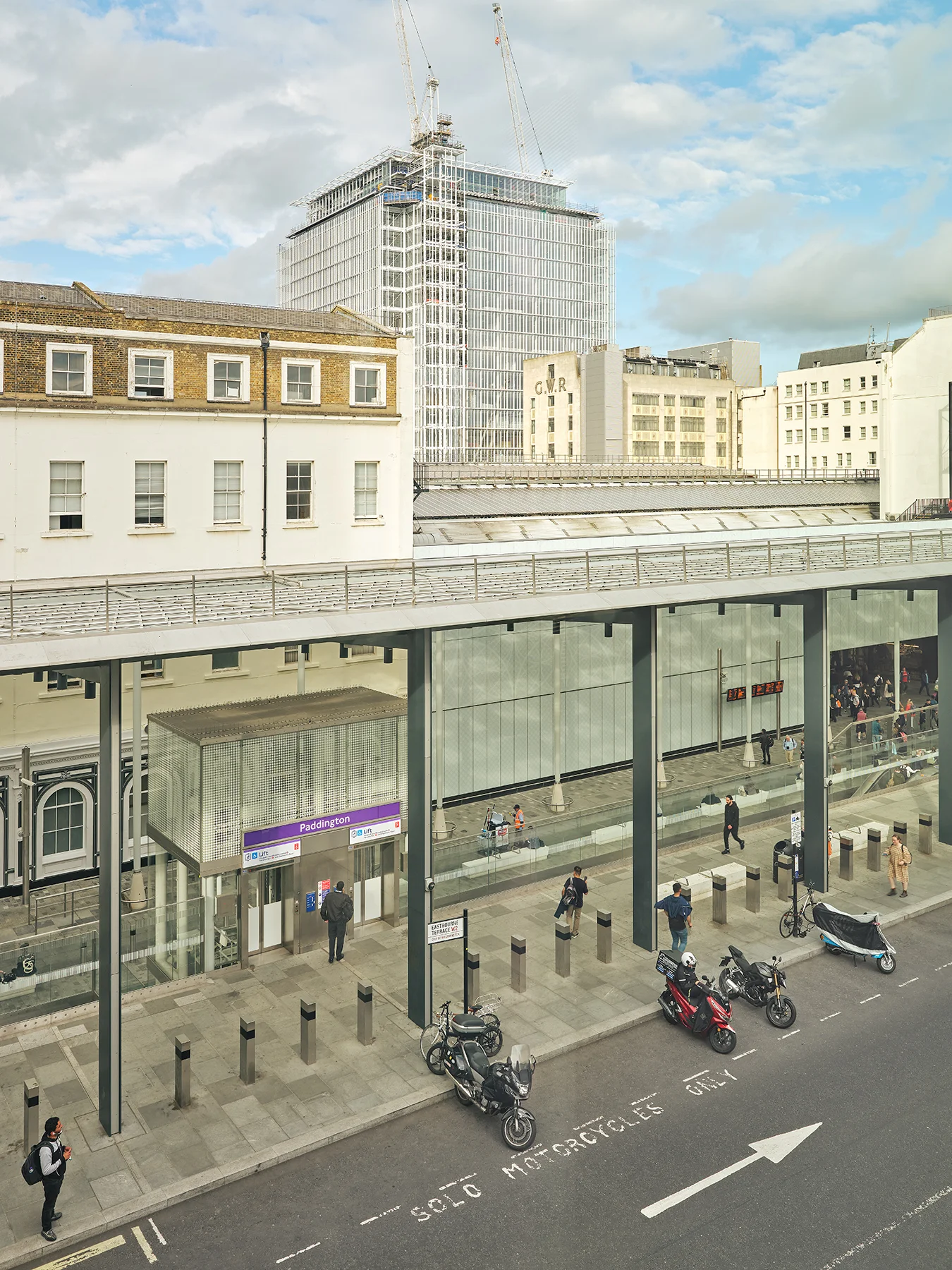 View of Paddington Station entrance with motorcycles and construction in the background