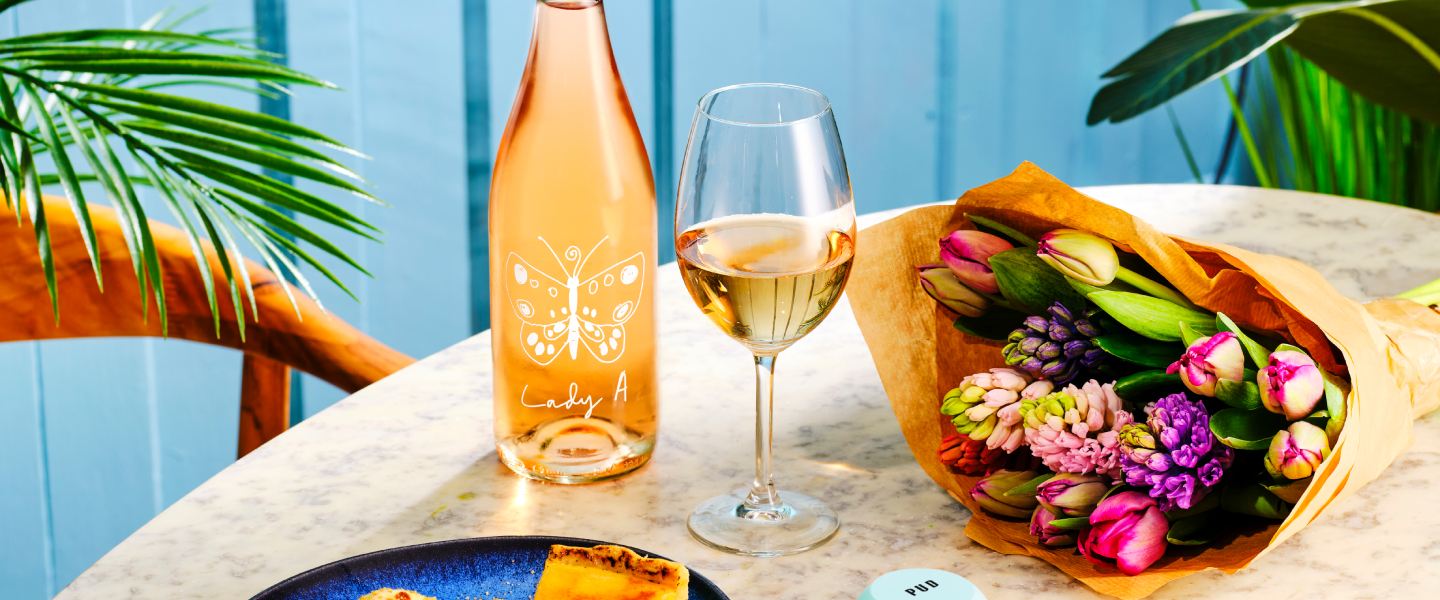 Flowers and glass of wine and bottle