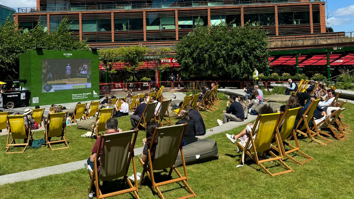 Public on deckchairs watching Wimbledon on the big screen at Cardinal Place