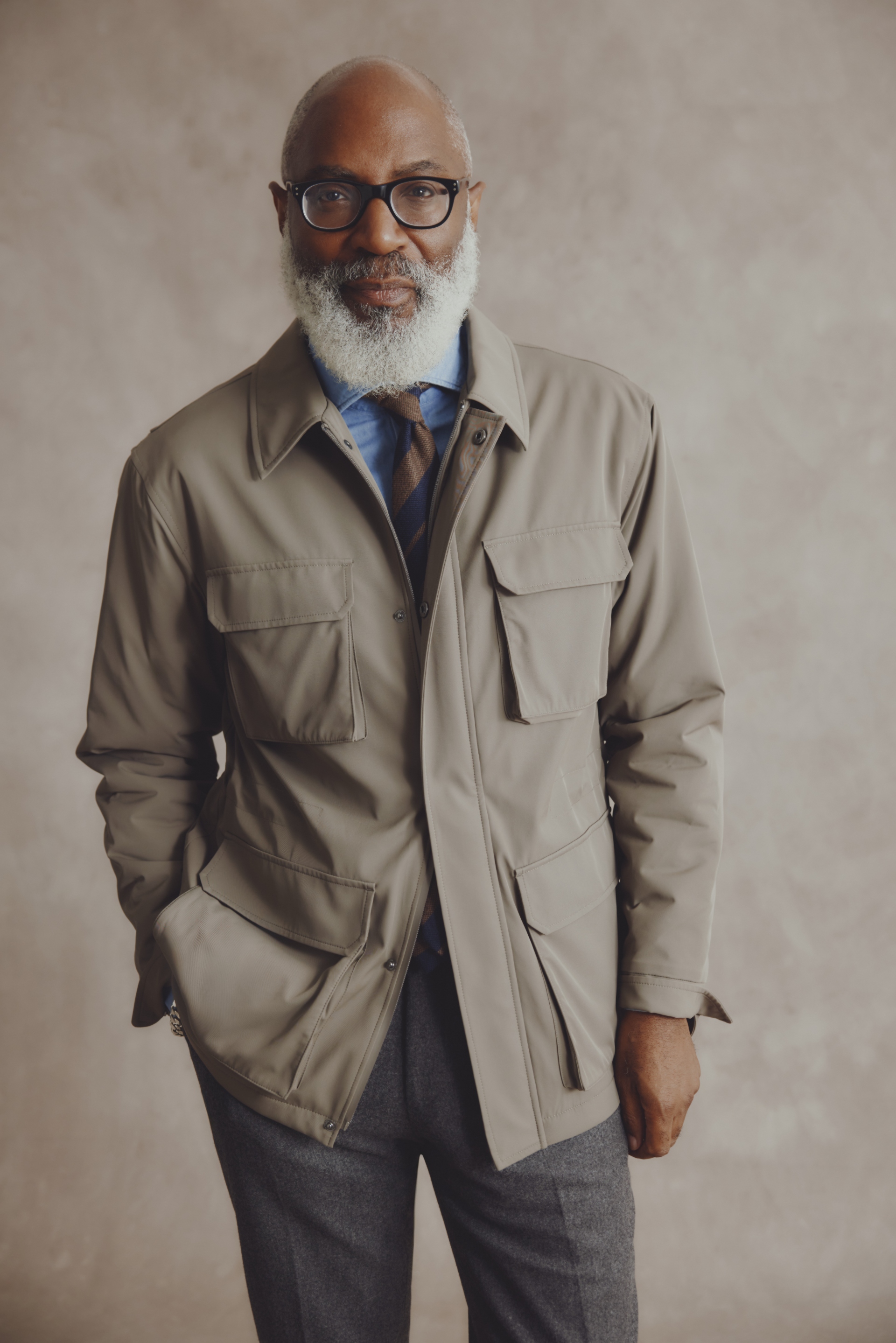 A man with a white beard wearing a formal jacket