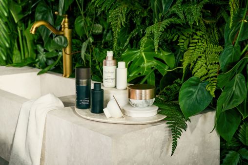 Rituals bath products on a tray in front of a green leafy backdrop