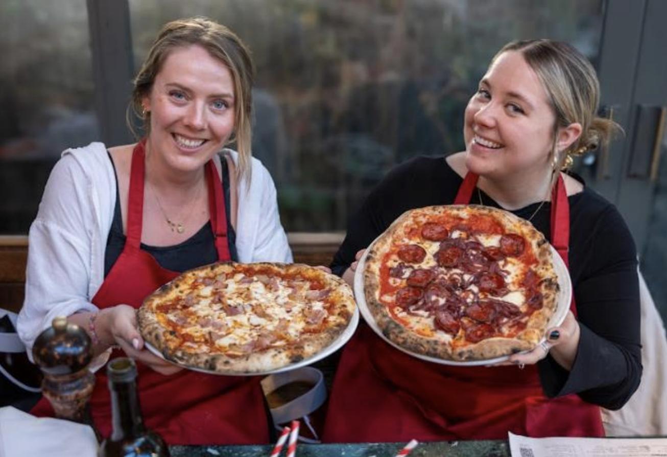 Two women taking a masterclass in pizza making at Franco Manca