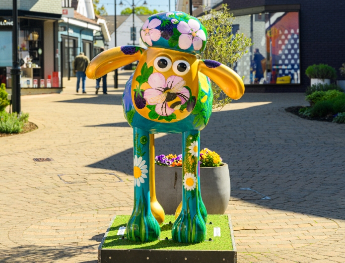 Three children stood in front of shaun the sheep model