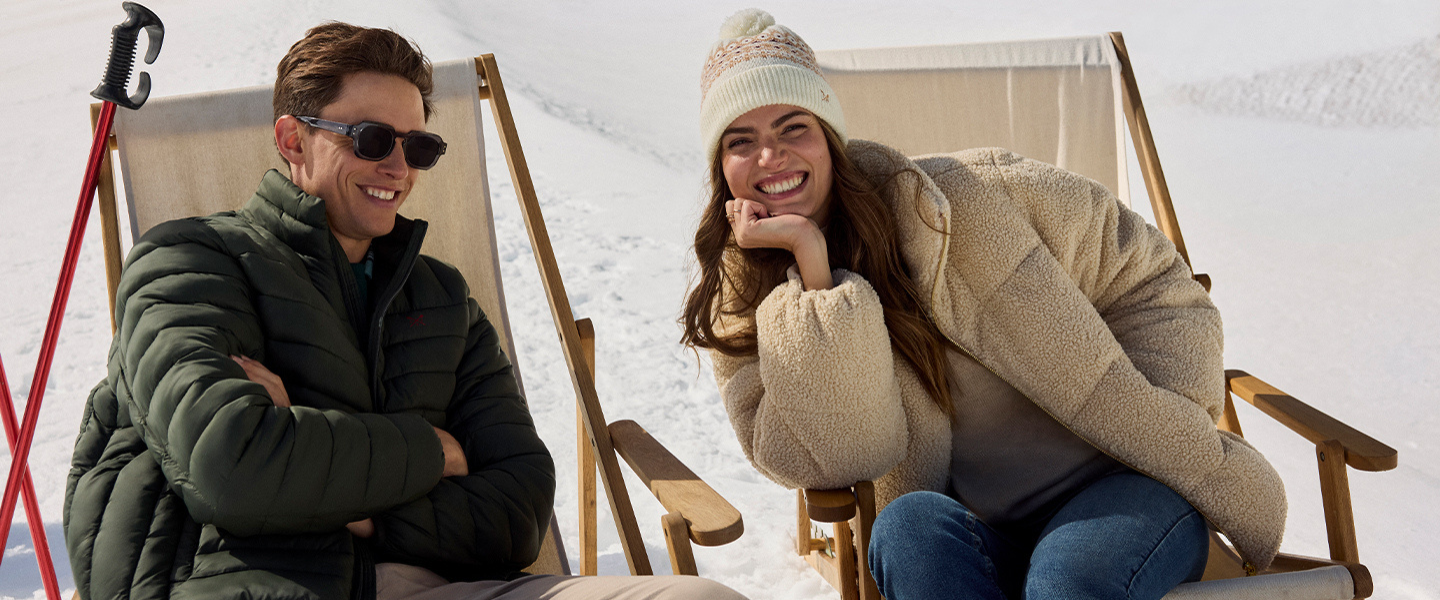 Two models on a ski slop wearing winter clothing from Crew Clothing