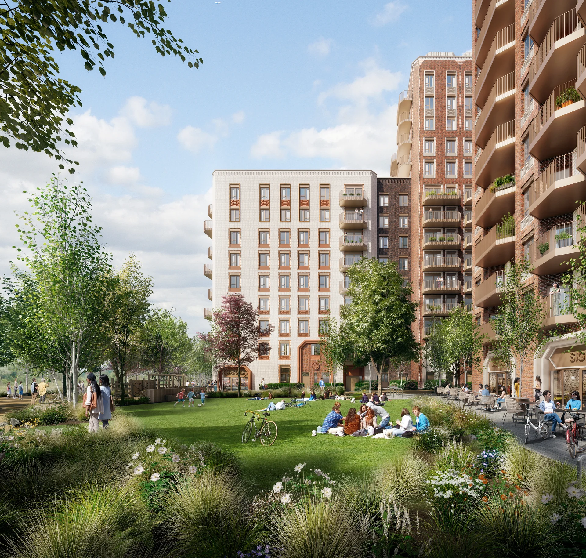 Modern residential buildings with balconies overlook a lush green park where people relax and play under a clear sky.