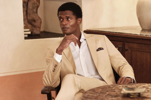 A man wearing a cream John Henric suit