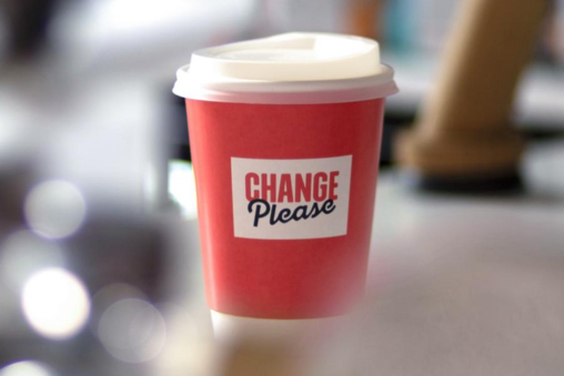 A pink Change Please coffee cup