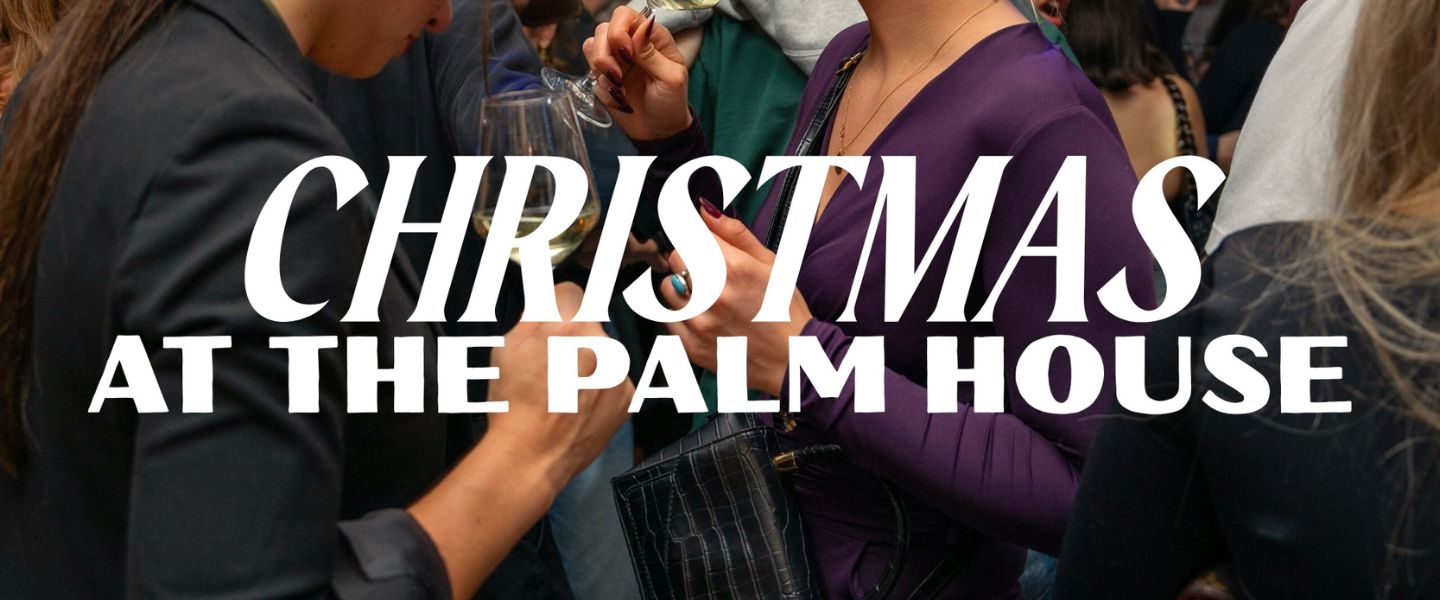 A close up of two women at a Christmas party with white text overlaid "Christmas at The Palm House"