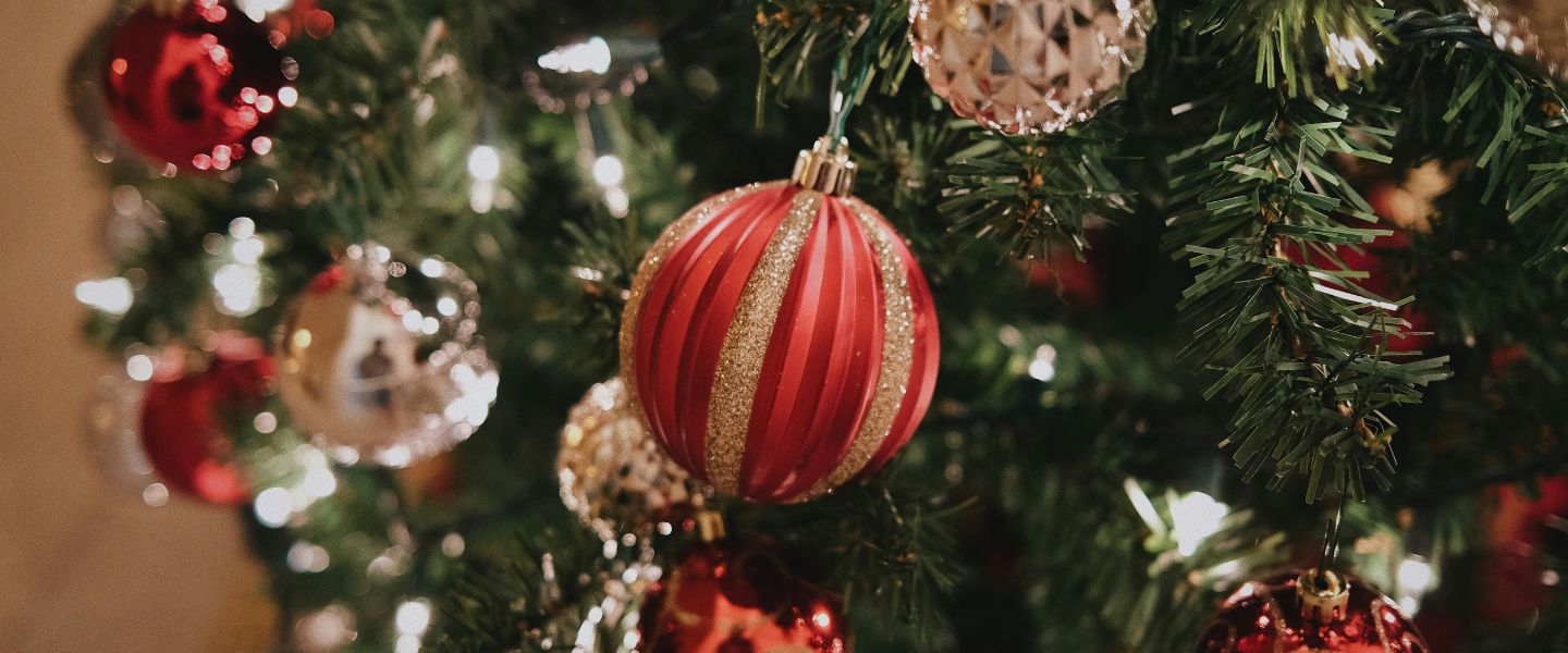 Red and gold Christmas baubles on a Christmas tree
